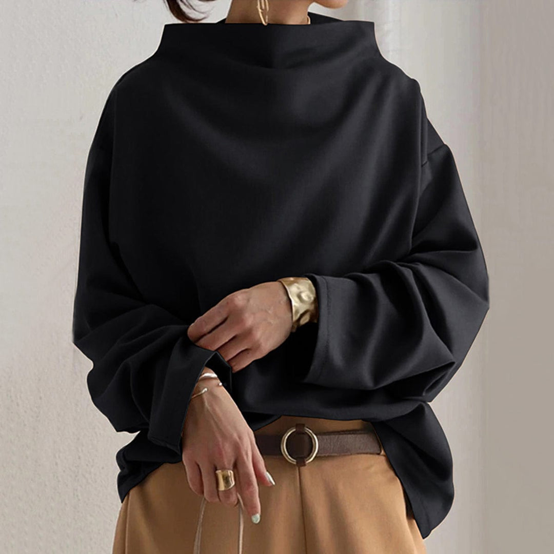 Women's black oversized funnel neck sweatshirt, front view on a model