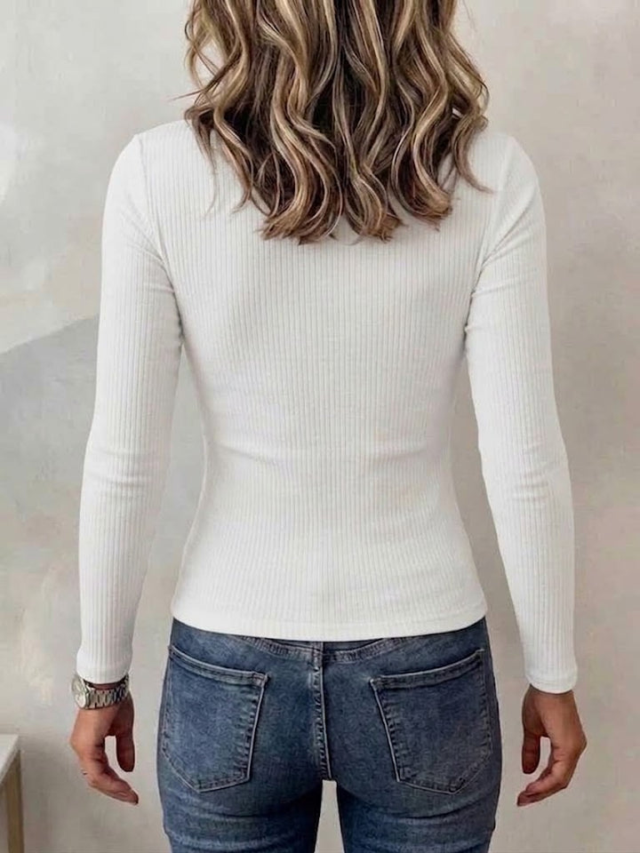 Back view of the white ribbed top worn with blue denim