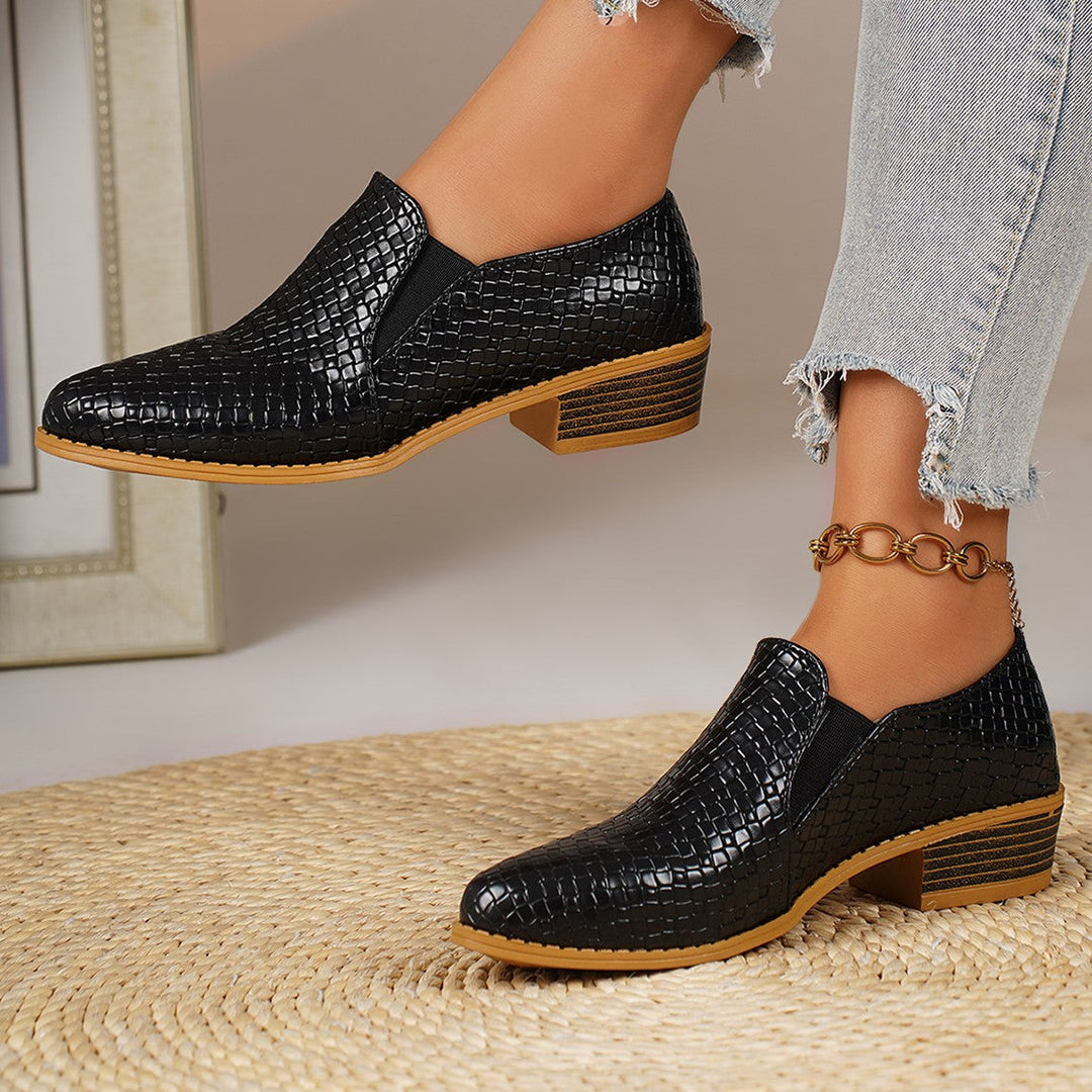 Black woven look loafer front view with the other foot in the background