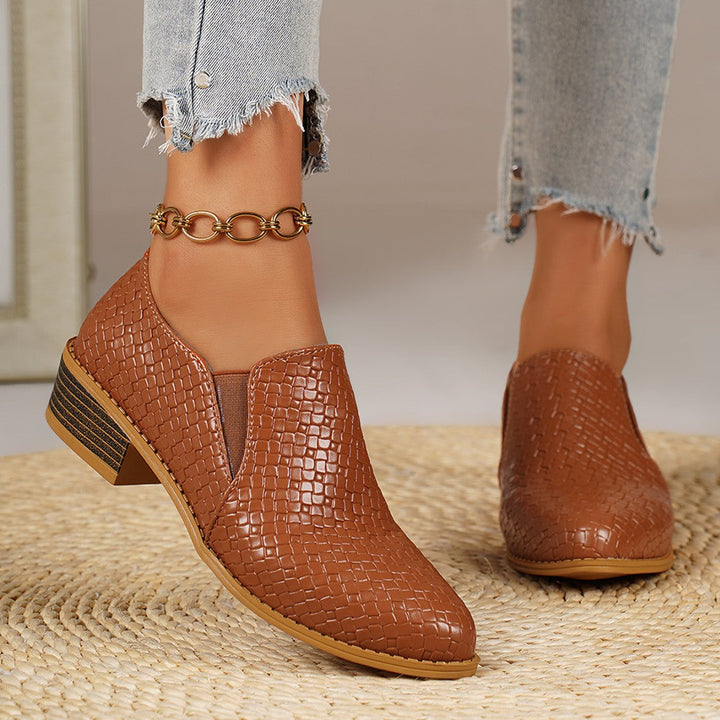 Cognac slip on loafers from the side, showing the low stacked heel