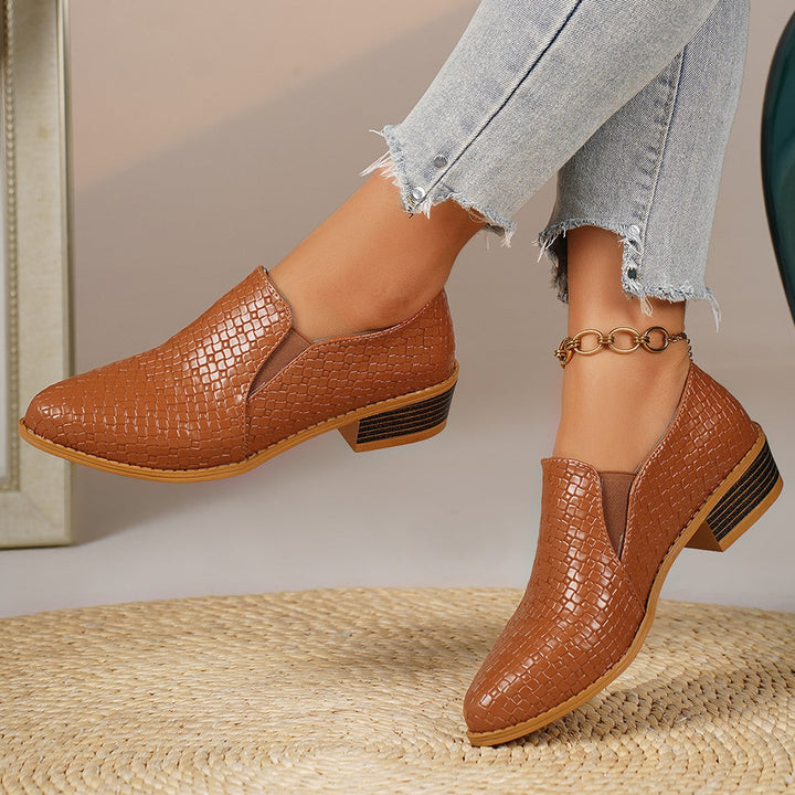 Cognac slip on loafers with block heel, side view worn with frayed jeans