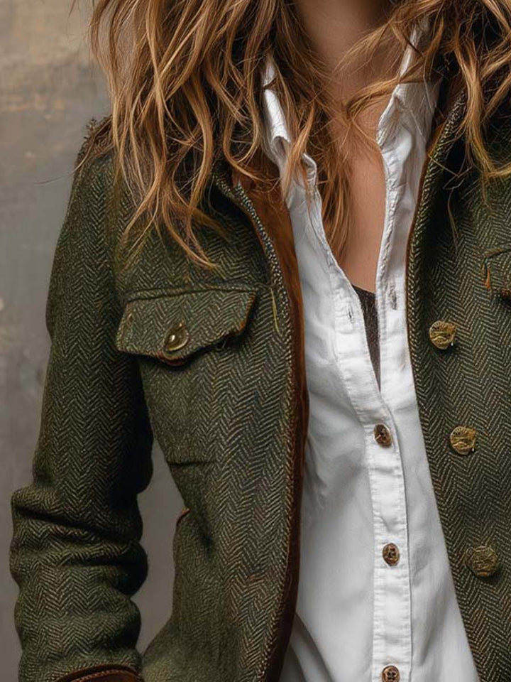 Close-up of the herringbone blazer chest patch pocket and button front