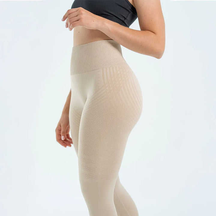 Beige high waisted leggings with textured stripes, rear three quarter view