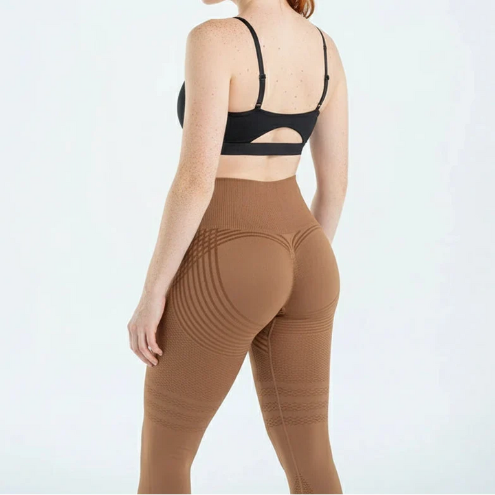 Brown high waisted leggings with a sports bra, back view