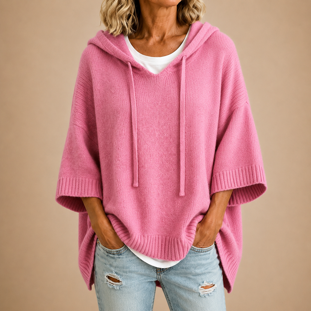 Pink knit hooded poncho sweater with three quarter sleeves, front view