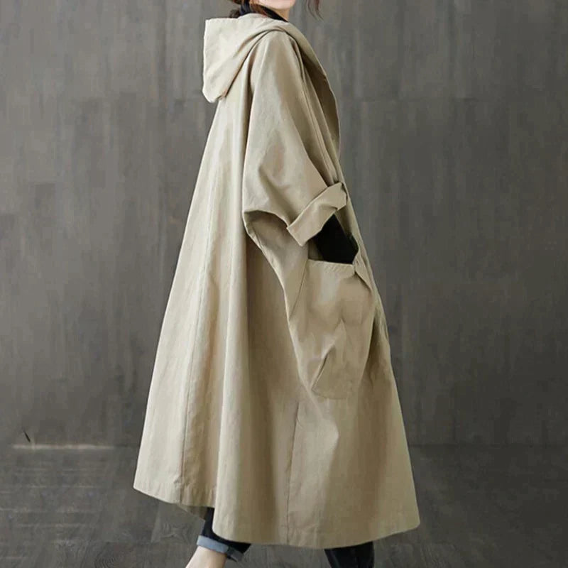 Side view of the khaki oversized hooded coat showing the loose drape and hood