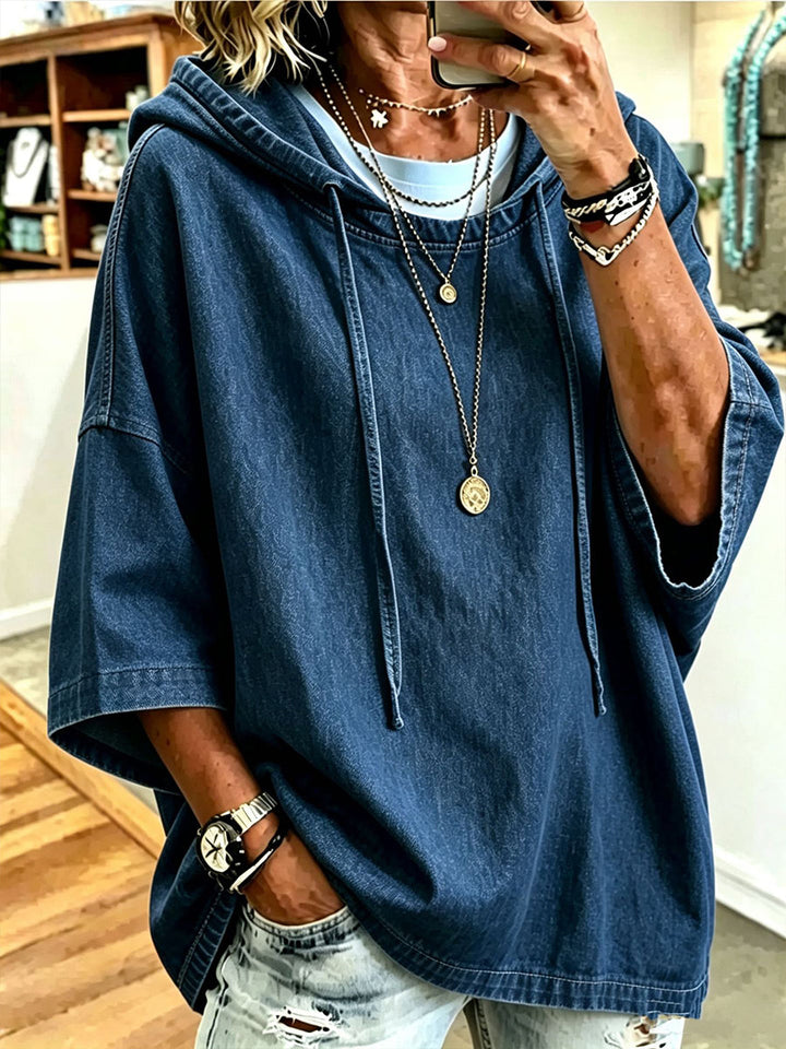 Dark blue denim-look hoodie worn loose over ripped light denim
