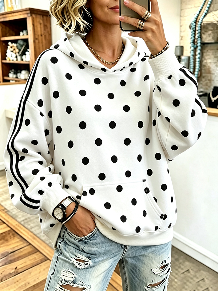White hoodie with black polka dots and black sleeve stripes