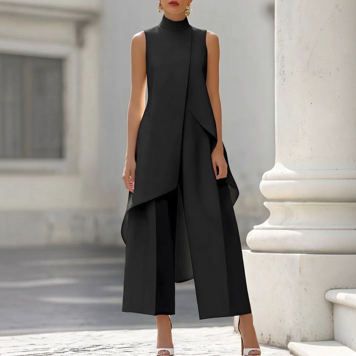 Black mock neck wide leg jumpsuit with asymmetric drape on a stone terrace