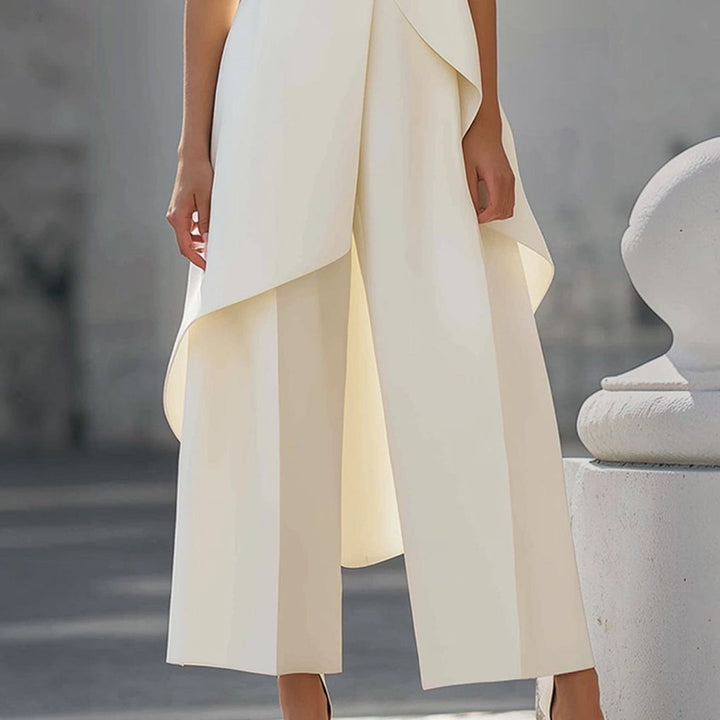 Detail of the ivory drape falling over the wide leg pants