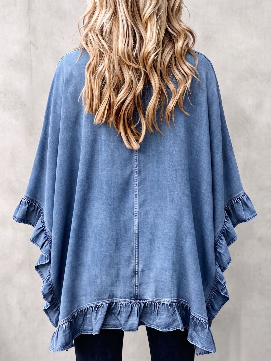 Back view of the denim blue kimono showing the ruffled hem and flowing shape