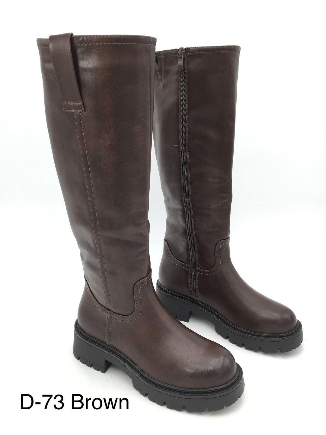 Pair of brown knee high boots on a white background with lug soles