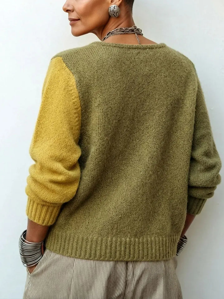 Back of the knit sweater with an olive body and one mustard sleeve