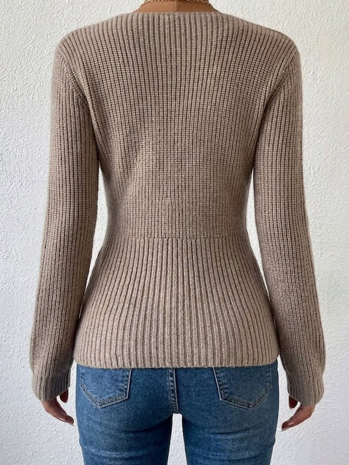 Back of the taupe ribbed sweater showing the fitted waist
