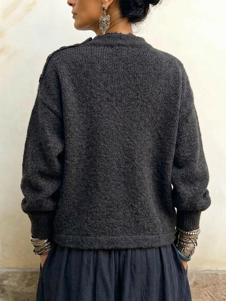 Back view of the charcoal sweater with dropped shoulders and ribbed cuffs