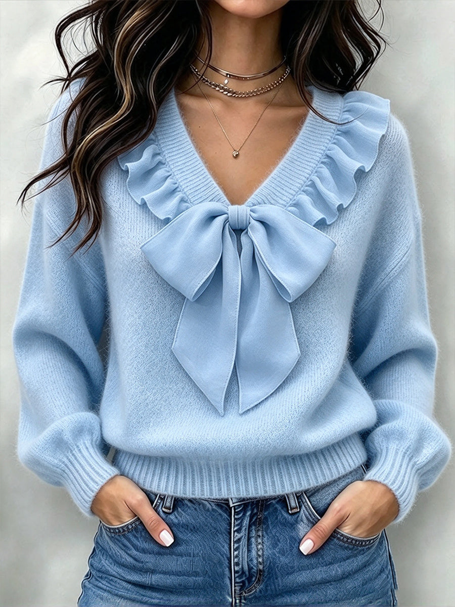 Light blue knit sweater with frilled V-neck and big tied bow, front view
