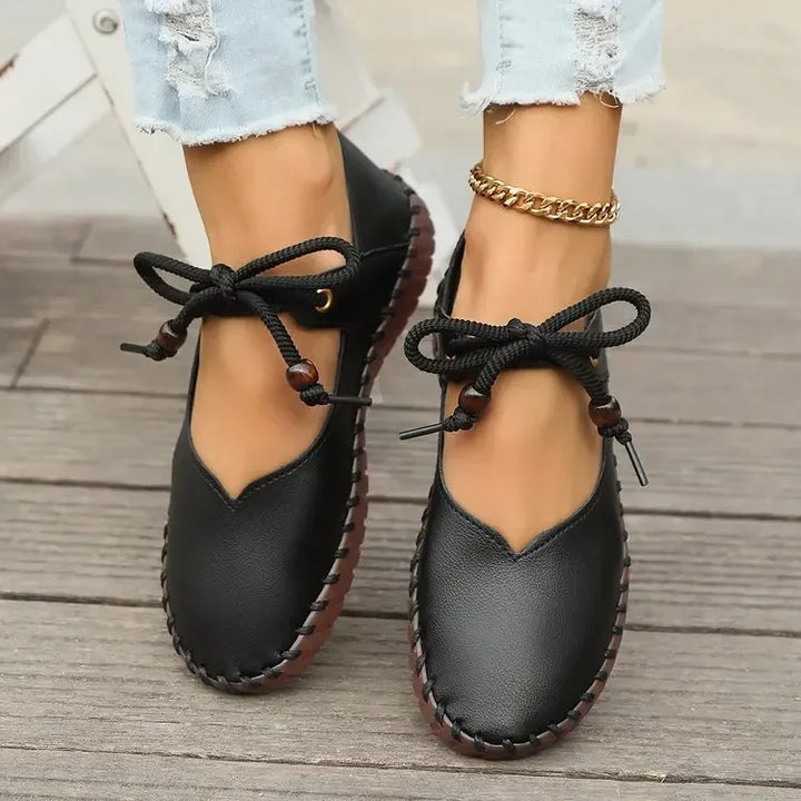 Pair of black lace up flats with stitched sole