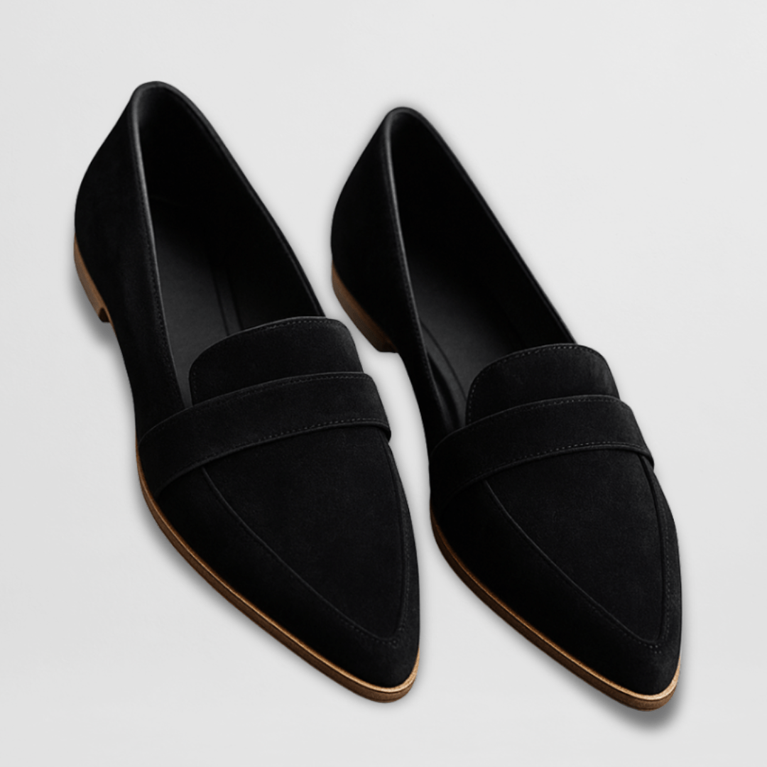Pair of black suede-look loafers with pointed toes on a light background