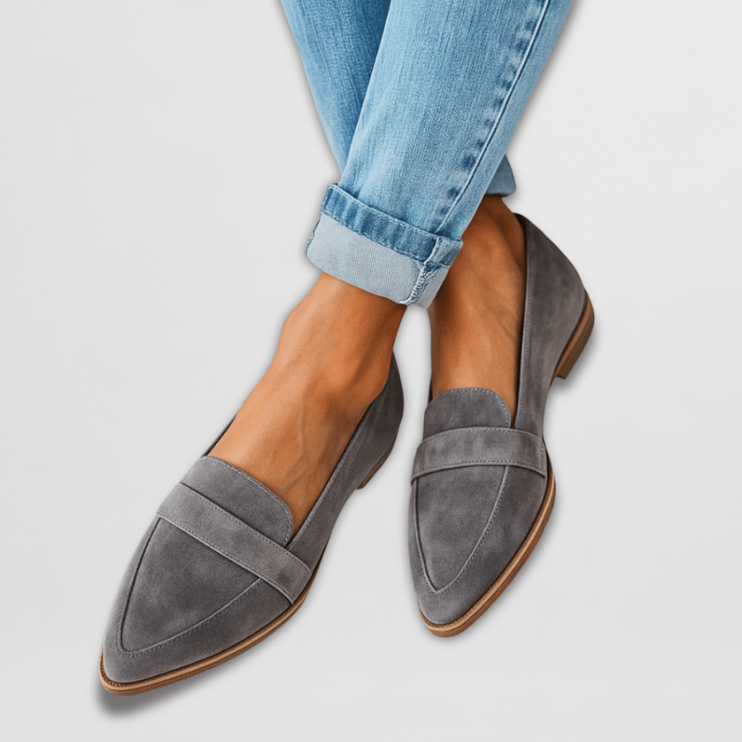 Gray pointed toe slip-on flats worn with cuffed light blue jeans