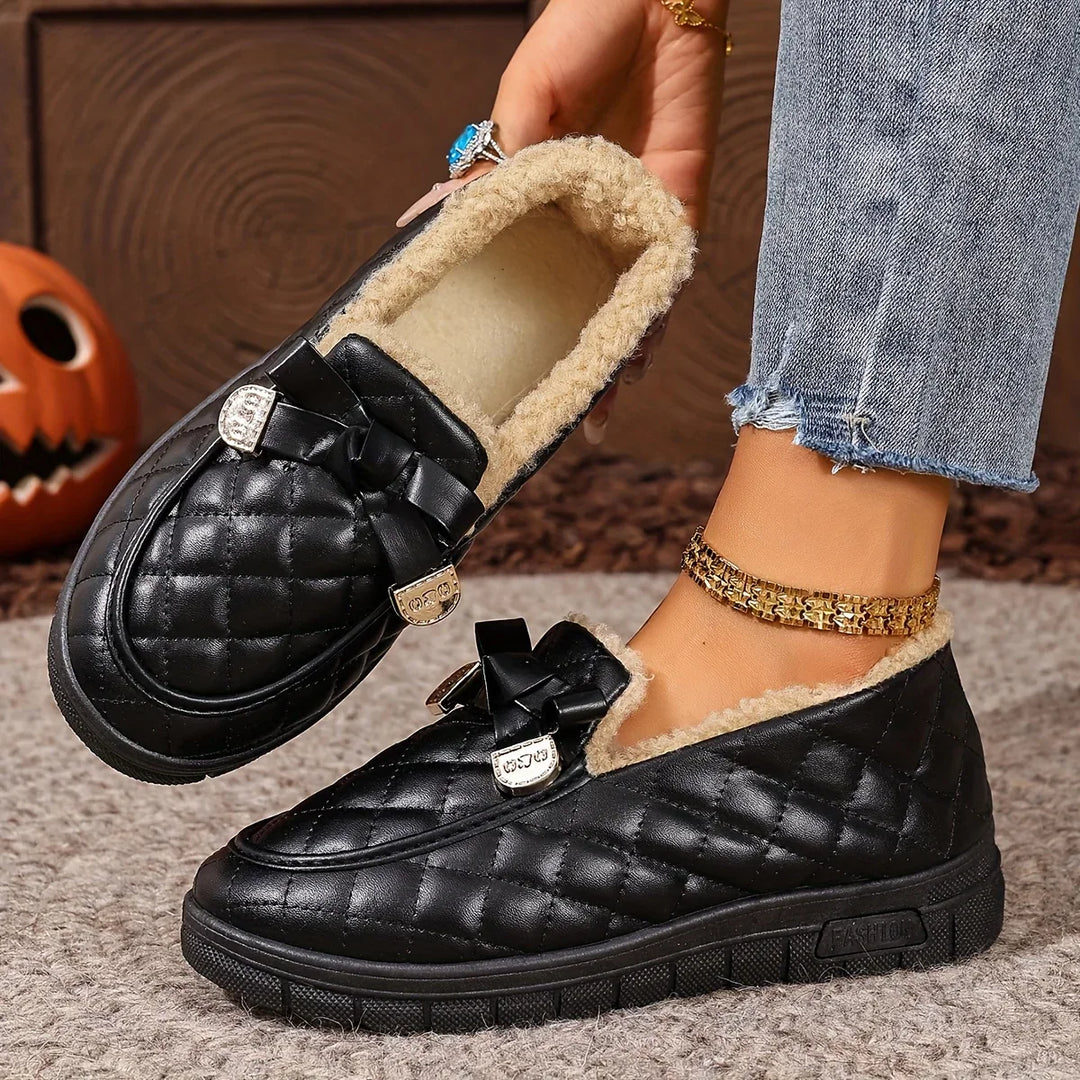 Side view of the black quilted loafer with moc toe