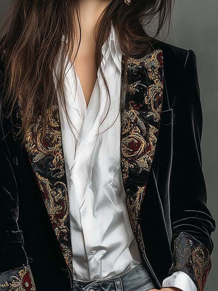Close-up front view of the black long blazer with paisley lapels over a white shirt