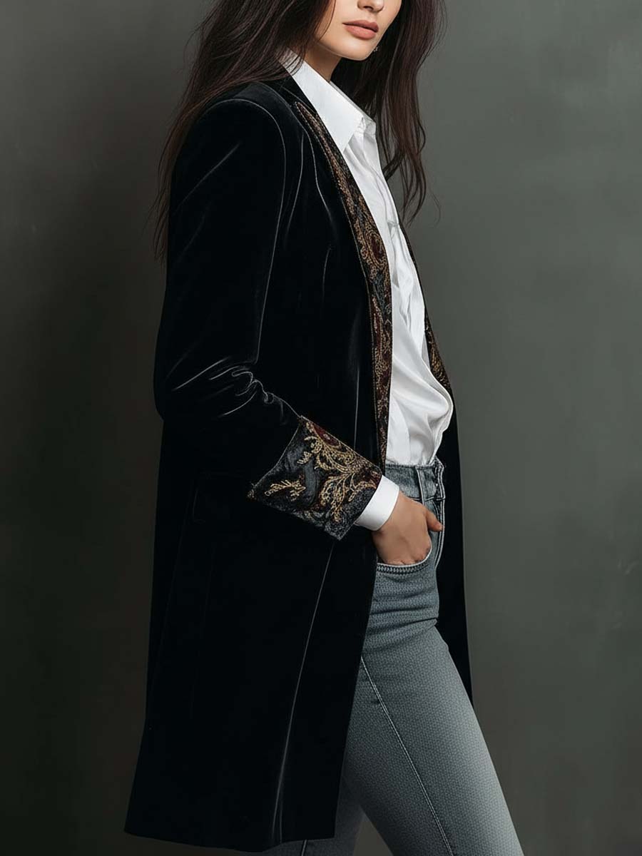 Side view of the black velvet-look long blazer with paisley cuff