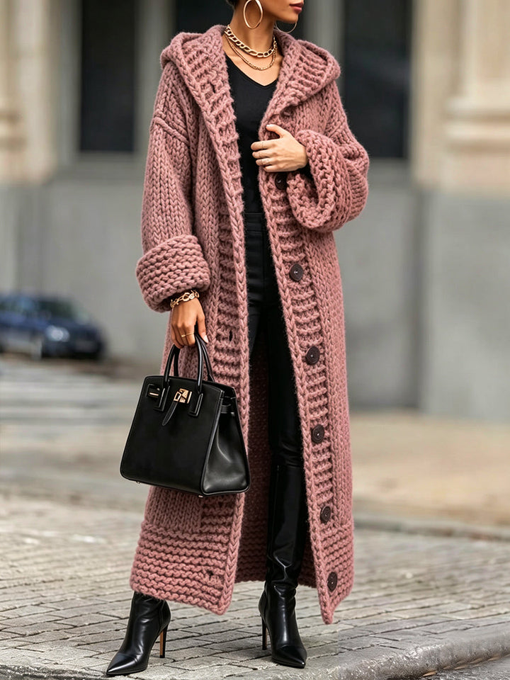 Dusty pink ankle-length knit cardigan worn over an all-black outfit