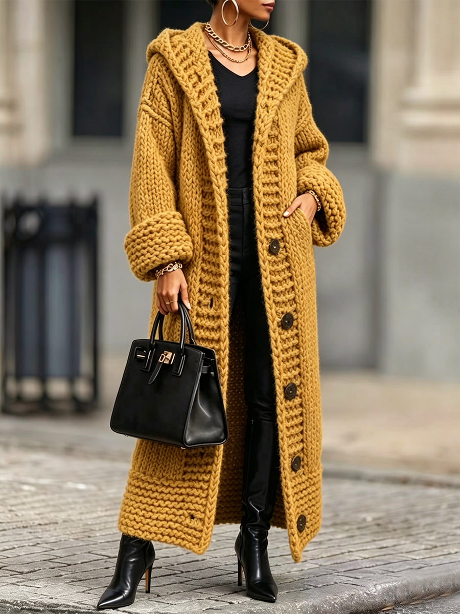 Mustard long knit cardigan styled with heeled boots and a black bag