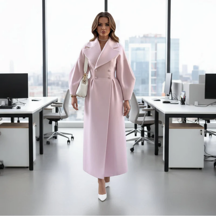 Pale pink long coat with balloon sleeves worn in a bright office