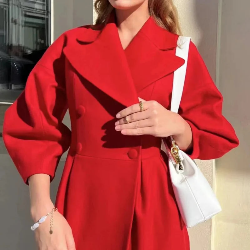Close view of the red coat lapels, buttons and balloon sleeve