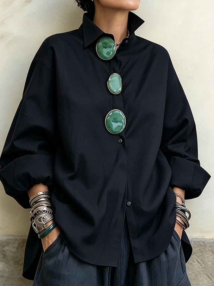 Black oversized shirt with three large green stone-look buttons