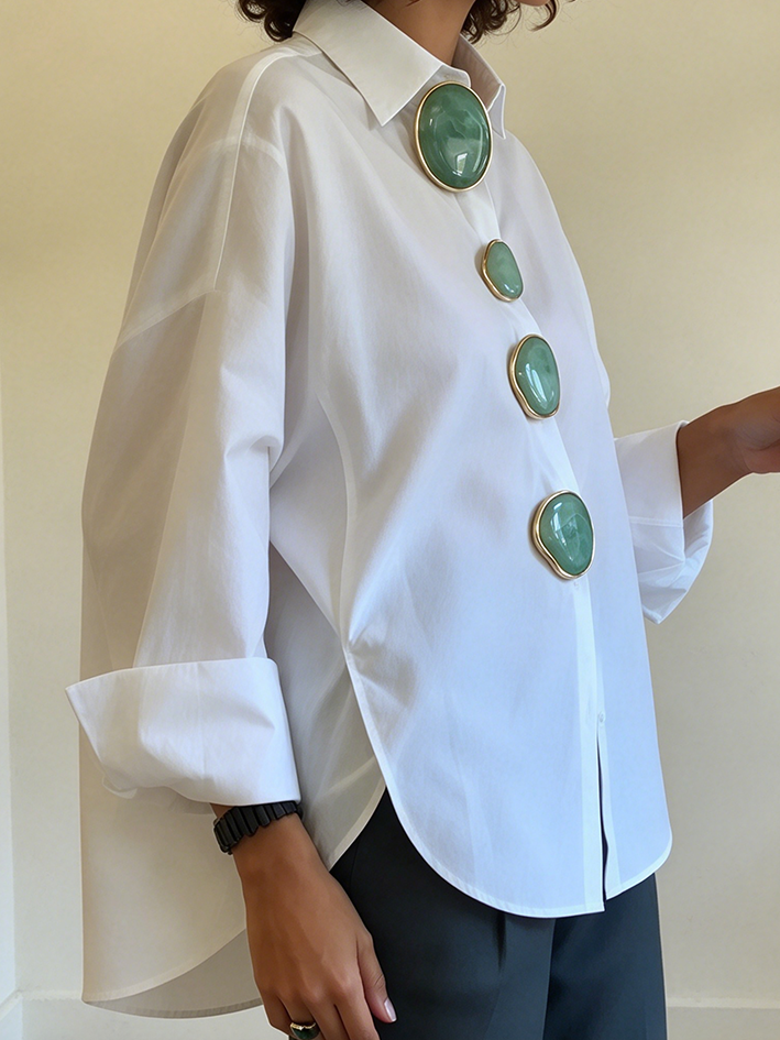 Side view of the white shirt showing the curved, longer back hem