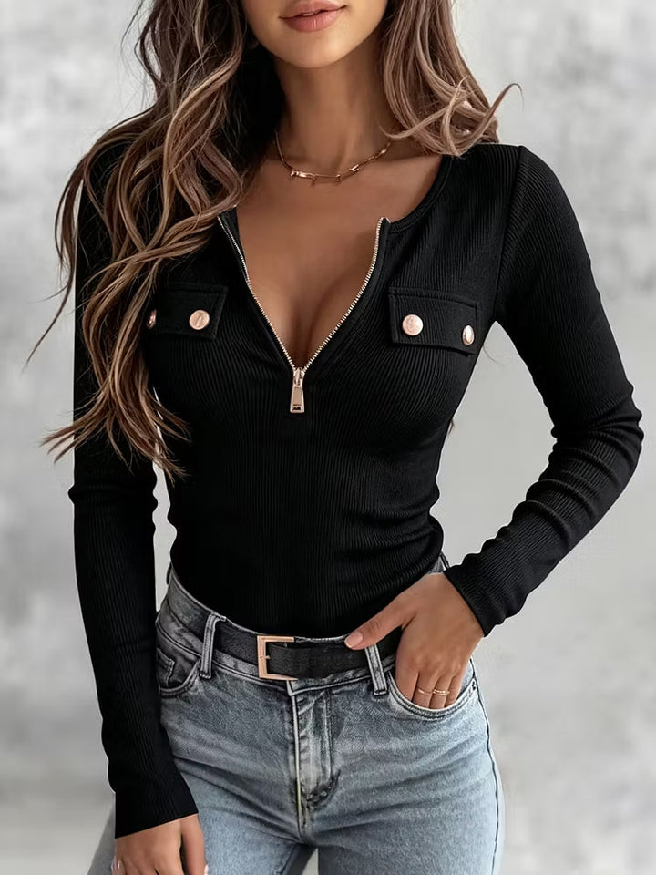 Black half-zip top with gold snaps on both chest pockets