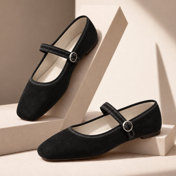 Black square toe Mary Jane flats with buckle strap, pair on beige blocks