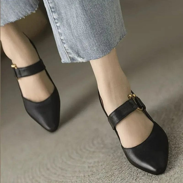 Black pointed toe Mary Jane heels with ankle strap worn with jeans