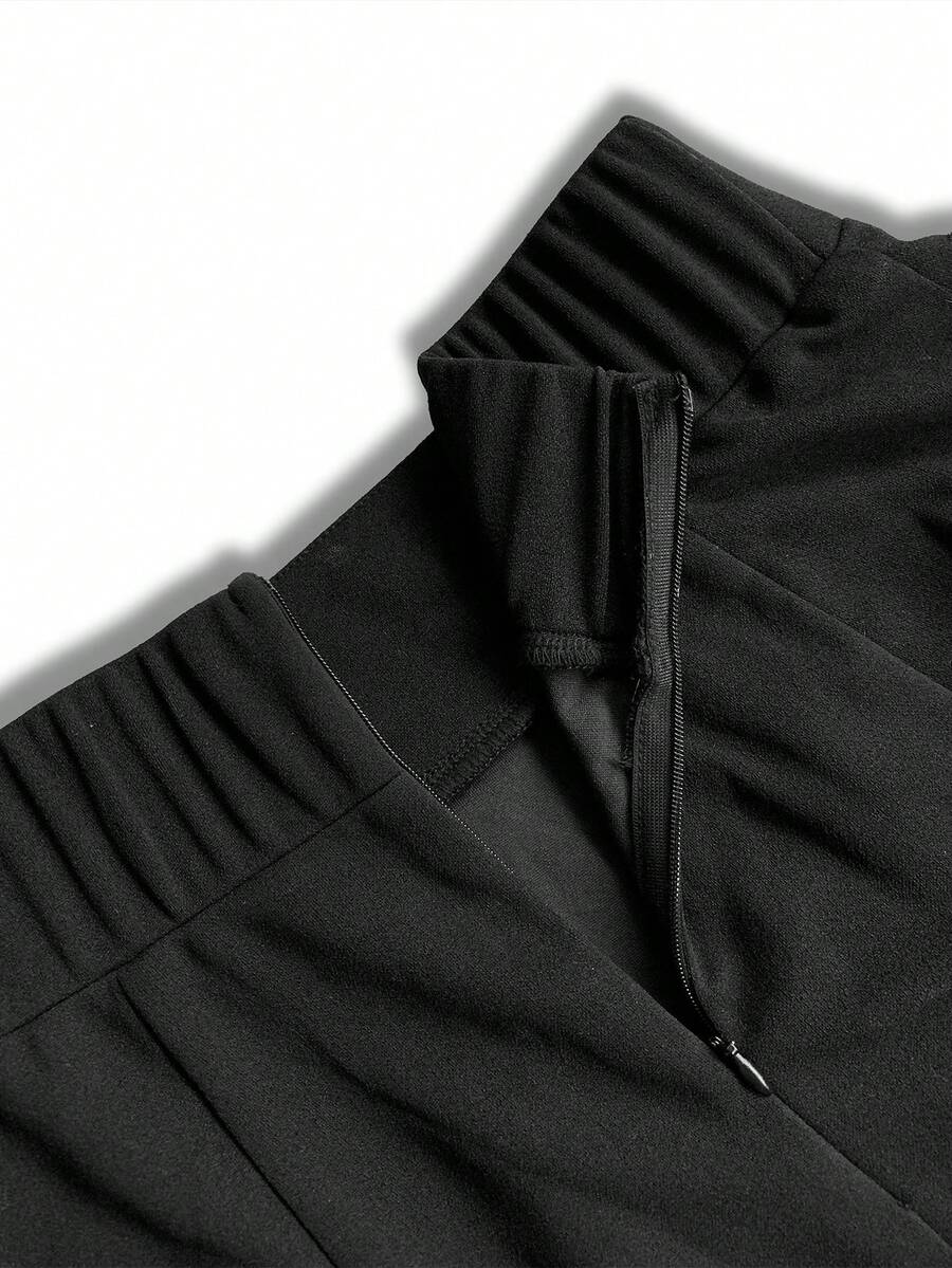 Inside view of the elastic back waistband and side zipper on the black maxi skirt