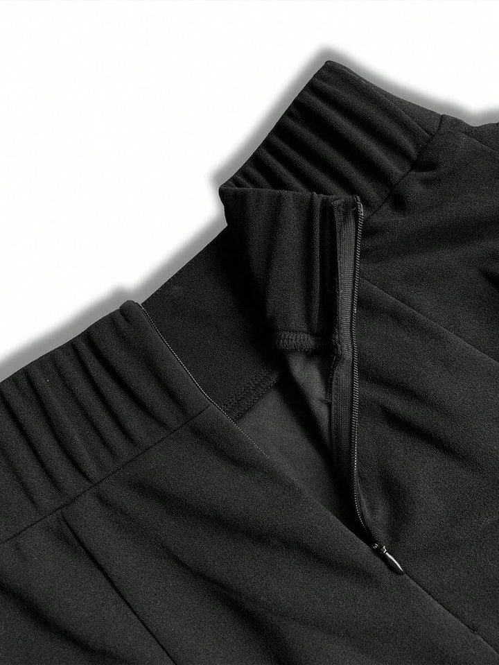 Inside view of the elastic back waistband and side zipper on the black maxi skirt
