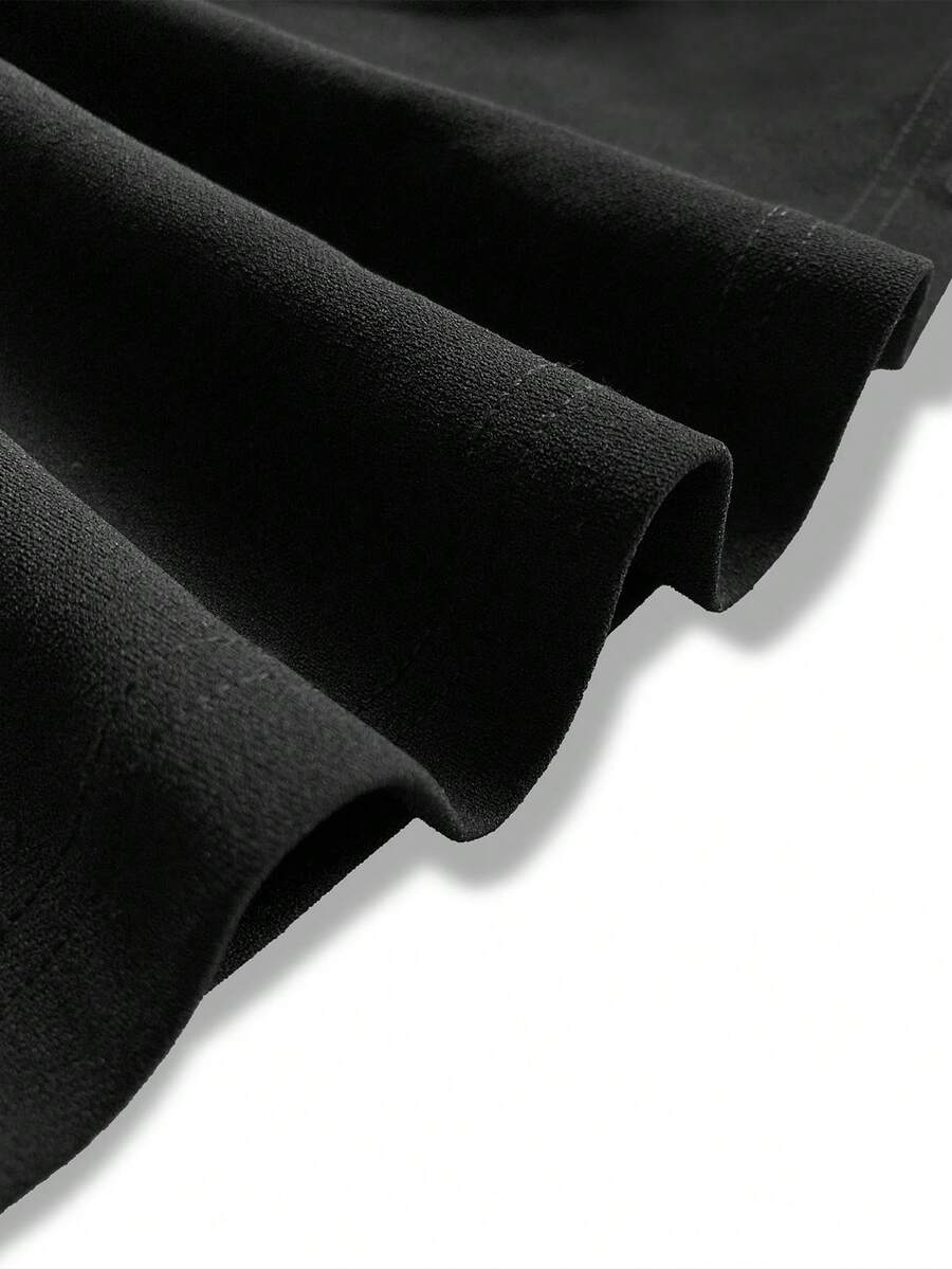 Close-up of the soft folds in the black maxi skirt fabric