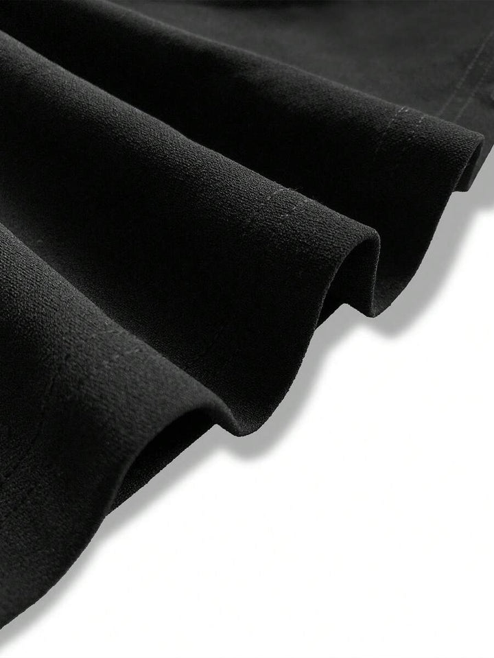 Close-up of the soft folds in the black maxi skirt fabric