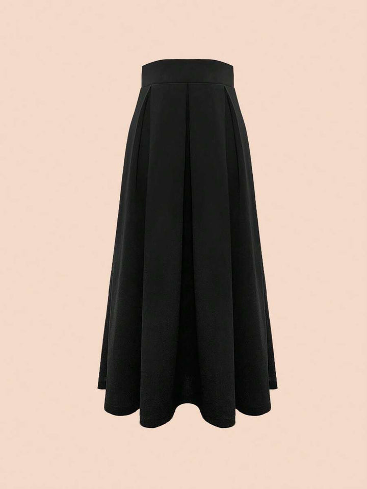 Black A-line maxi skirt shown flat against a blush pink background