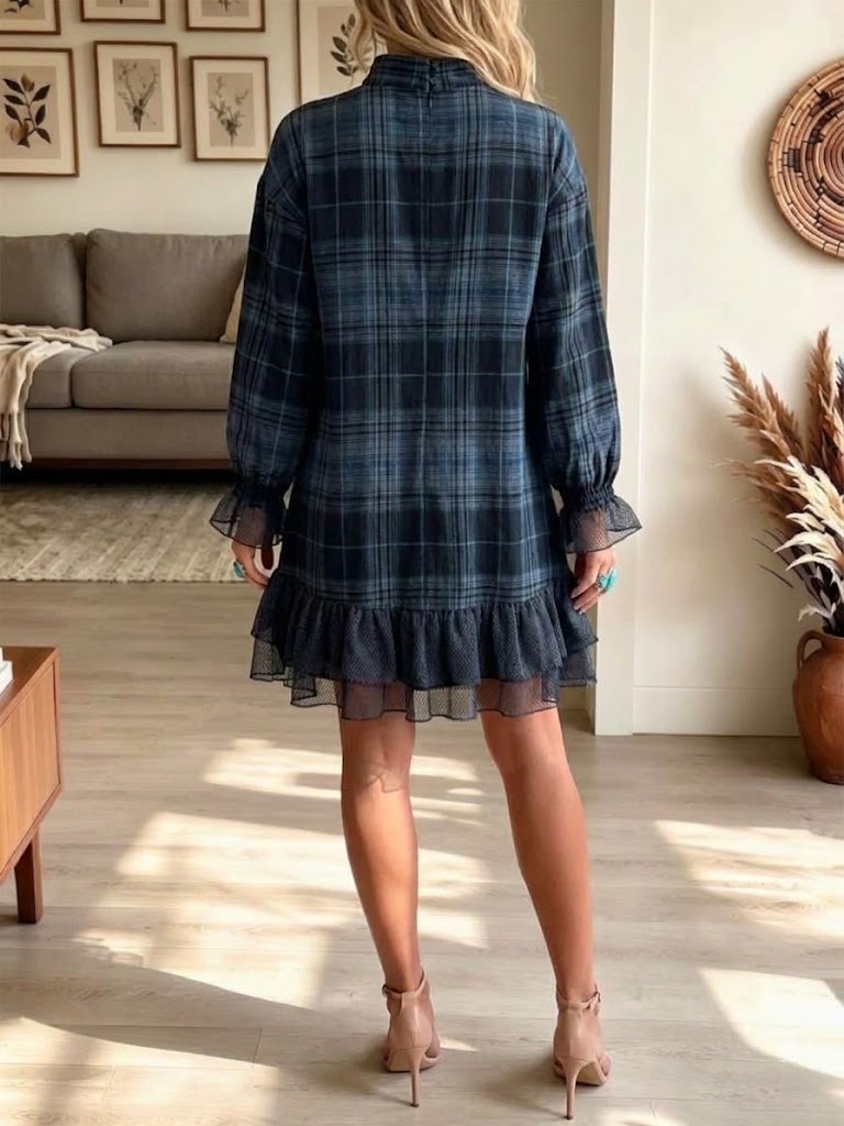 Back view of the plaid mini dress showing the long sleeves and ruffled hem