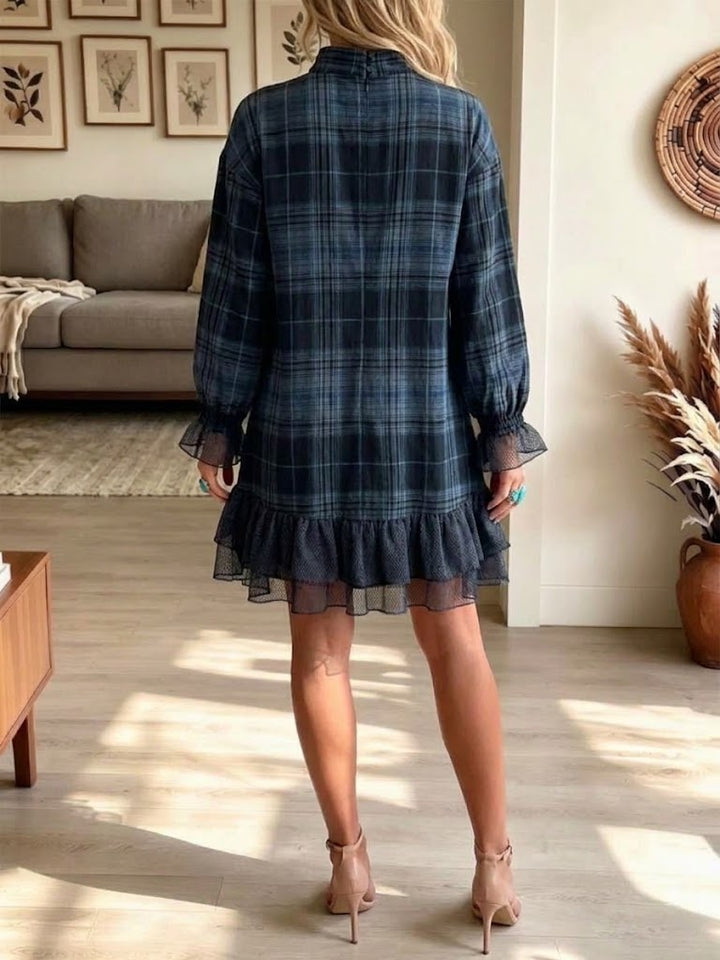 Back view of the plaid mini dress showing the long sleeves and ruffled hem