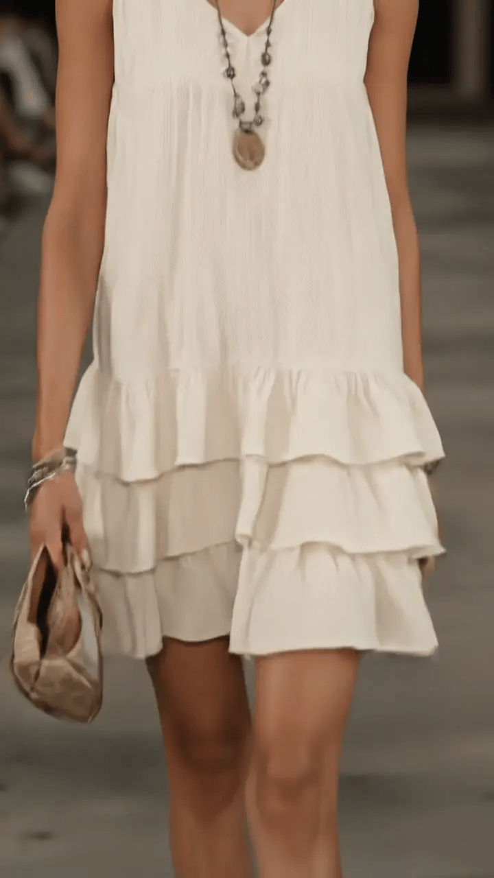 Close view of the cream dress showing the tiered ruffle hem