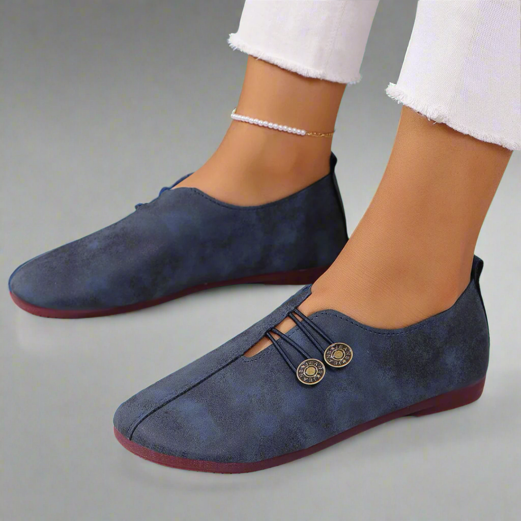 Navy moccasins with button laces and red sole edge