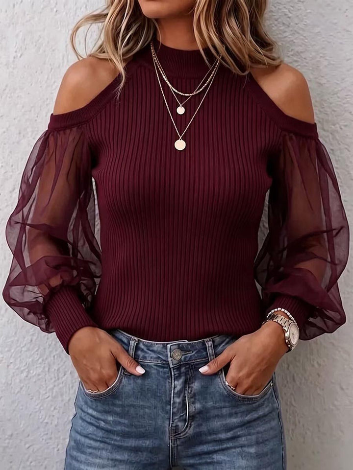 Burgundy cold shoulder sweater worn with layered gold necklaces