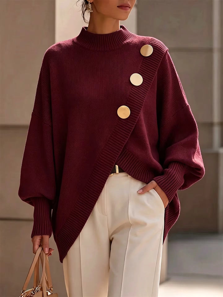 Burgundy oversized mock neck sweater with asymmetrical gold buttons on a model, front view