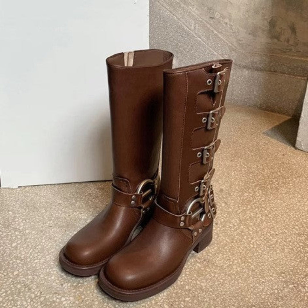 Brown tall motorcycle boots with buckle straps standing side by side