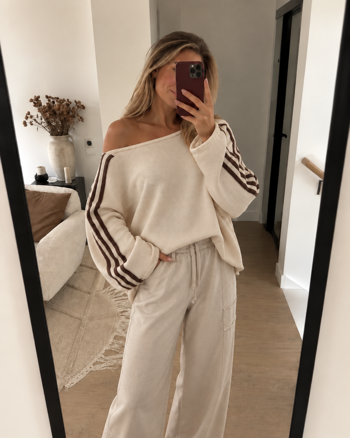 Cream off shoulder sweater with cream wide leg pants in a mirror selfie