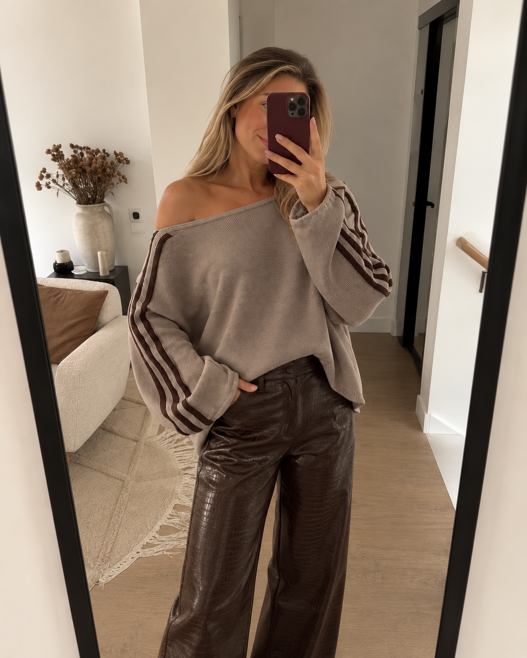Taupe oversized sweater worn with brown leather pants in a mirror selfie
