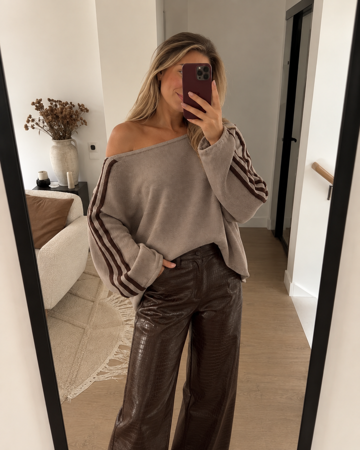Taupe oversized sweater worn with brown leather pants in a mirror selfie